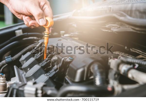 Closeup of hand a man\
check engine a car