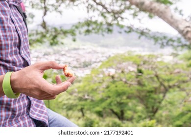 Closeup To The Hand Of A Man Holding A Jinotegan Empanada