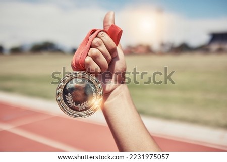 Closeup, hand and medal for winning, success on track for marathon for wellness, outdoor and sports. Victory, athlete and winner holding gold award, achievement and competition for goal and champion.