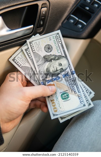 Closeup hand money in car and money\
for loan credit financial, lease and car rental\
concept