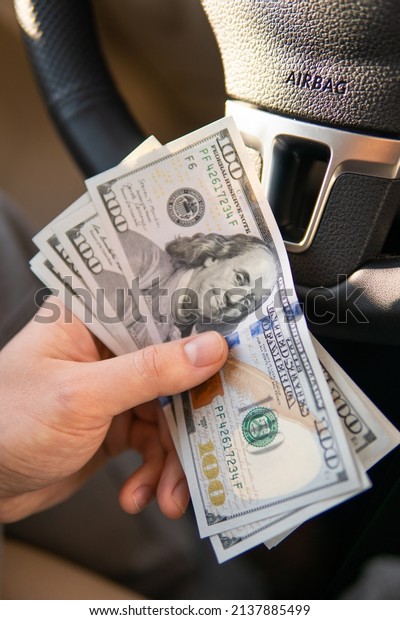 Closeup hand money in car and money\
for loan credit financial, lease and car rental\
concept
