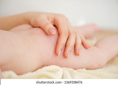 Close-up Of Hand On Baby Skin Butt.