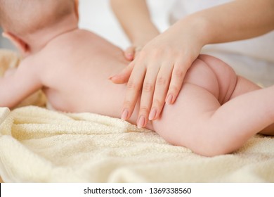 Close-up Of Hand On Baby Skin Butt.