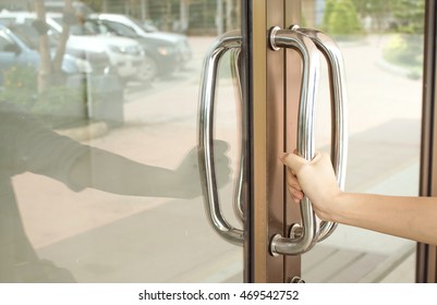 Close-up Of Hand Open Aluminum Glass Door Holding Handle.