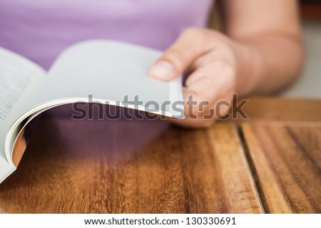 Closeup hand open book for reading concept background