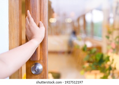 Closeup Hand Open The Glass Door By Pushing At The Wooden Handle To Go Inside The Restaurant