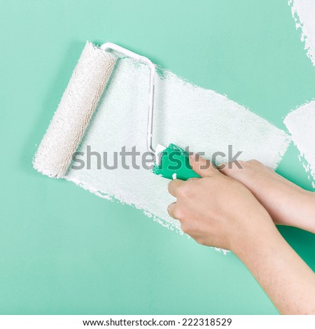 Closeup of a hand with paint roller