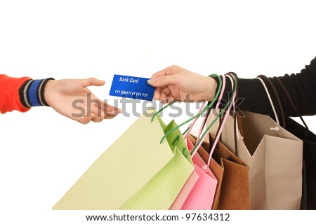 Close-up of hand passing over credit card to shop assistant after shopping MasterCard
