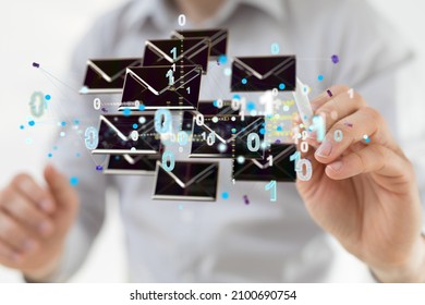 A closeup of the hand with a pen pointing at the floating email icons and binary numbers 