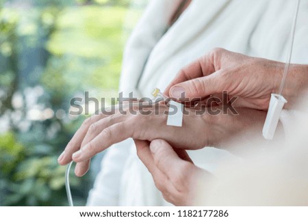 Close-up of a hand with a peripheral venous access catheter