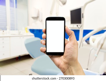 closeup of a hand phone at the dentist - Powered by Shutterstock