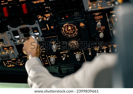 close-up hand of the pilot captain presses the buttons on the control panel to start the engine of plane Flight simulator close-up