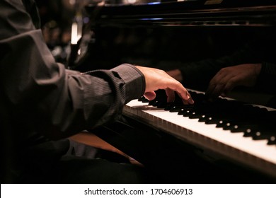 Close-up of a  hand playing the piano