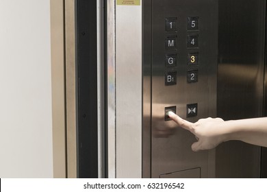 Close-up Hand Press The Button Open The Elevator Door