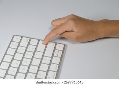 Close-up of Hand Pressing Enter Key on Keyboard