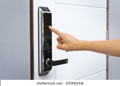Close-up hand pressing keywords to lock and unlock door - Door access control keypad with keycard reader