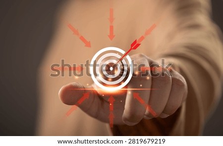 Close-up of a hand selecting a target on a virtual interface. Concept of business goals, strategic planning, target audience, marketing strategy, objective achievement, focus, and success management.