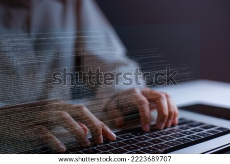Close-up of hand of software developer writing code on laptop.