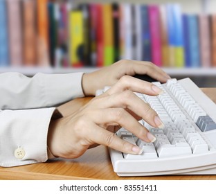 Close-up of secretary’s hand touching computer
