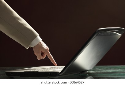 Close-up of  hand touching computer keys during work