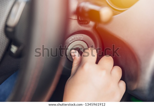 closeup hand twist turn car key to start ignite\
engine for drive.