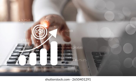Close-up hand using a calculator with a graph and profit target icon, concept of financial growth, income increase, and business success.