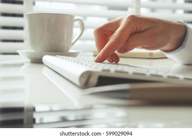Closeup of hand using computer keyboard. Closeup of businesswoman hand using computer laptop keyboard 