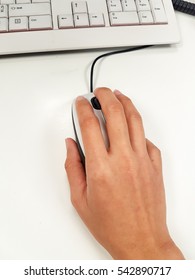 Closeup of hand using computer mouse.