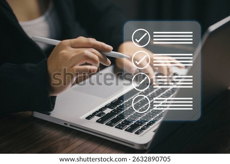 Close-up of hand using digital pen and typing on laptop with checklist icons overlay. Symbolizes task planning, productivity, to-do list, project management, and workflow organization.