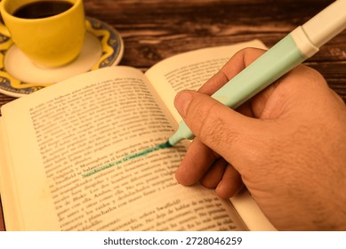 Close-up of a hand using a highlighter on an open book page with warm light. Concept of studying, exam prep, learning and focus. - Powered by Shutterstock - Get 15% off with code: PIKWIZARD15