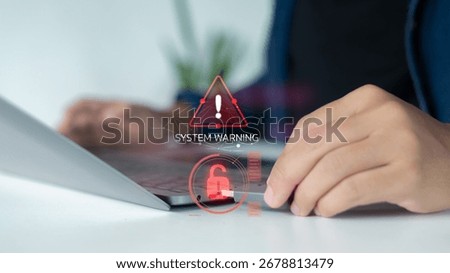 Close-up hand using a laptop with a digital warning alert and an unlocked padlock icon. Concept for cybersecurity, system warning, hacking, data breach, and online security risk.