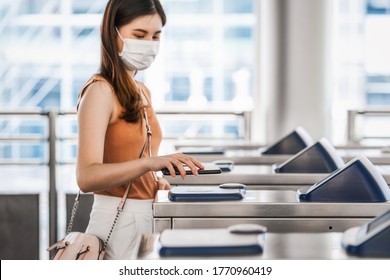 Closeup Hand Using Smart Mobile Phone Of Young Asian Woman Passenger Wearing Surgical Mask For Scanning The Automatic Machine By QR Code To Subway Or Bus Station When Traveling In Big City