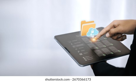 Close-up of hand using tablet with cloud storage and folder icon for secure data backup and file management. Concept of cloud computing, online storage, and digital data protection.