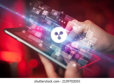 Close-up of a hand using tablet, currency concept