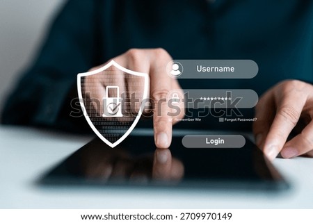 Close-up of hand using tablet with login interface and security shield icon, representing user authentication, password protection, secure access, identity verification and digital data privacy.