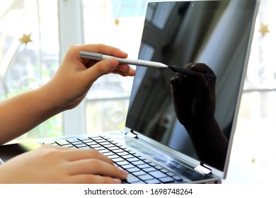 Close-up of Hand using tablet pc with stylus.