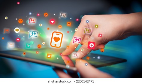 Close-up Of A Hand Using Tablet With Social Media Icons