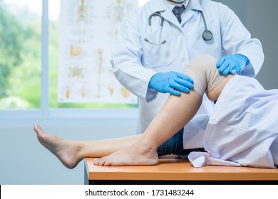 close-up hand wear medical gloves doctor examining head of patient with knee problems in clinic. - Shutterstock ID 1731483244