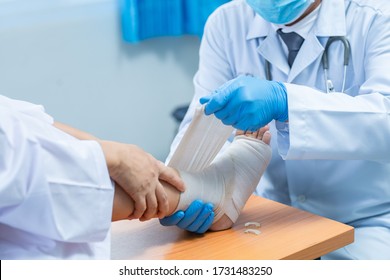 Close-up hand wear medical gloves  Of Doctor Hand Tying Bandage On The Leg Of Patient In Clinic, osteophytes and heel, fascia