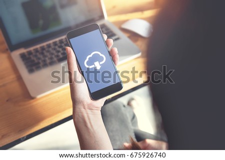 Closeup hand of woman with Cloud download on mobile smartphone.