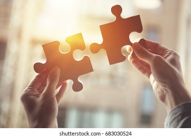 Closeup hand of woman connecting jigsaw puzzle with sunlight effect, Business solutions, success and strategy concept - Shutterstock ID 683030524