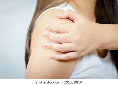 Closeup Hand Of Woman Hold Shoulders With Pain, Upper Arm Pain, Sprains. 