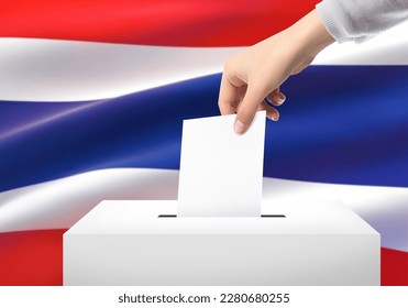 Close-up hand of woman hand woman holding ballot paper for election vote at thailand national flag background. Thailand voting concept.