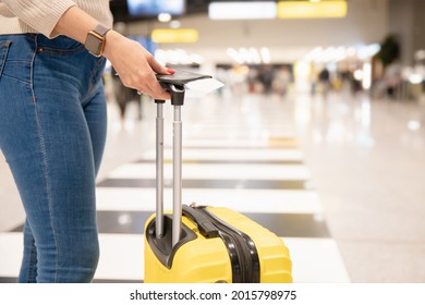 Closeup Hand Woman Holding Phone And Yellow Suitcase Luggage With Passport And Plane Ticket At Airport.