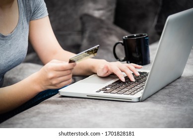 Closeup Hand Woman Holding SME Credit Card And Using A Keyboard Laptop Computer To Buy Products Payment Shopping Online, Spend Money, E-commerce Internet Banking For Remote Security At Home Concept