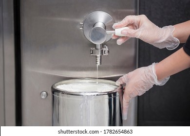 Close-up Of The Hand Of A Worker Who Fills Fresh Milk From A Milk Tank - Preparing Milk For Ice Cream In Modern Dairy Factory - Macro Photography