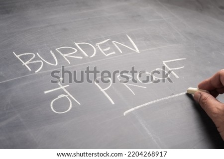Closeup hand write the text Burden of Proof, on the blackboard, topic of law learning concept