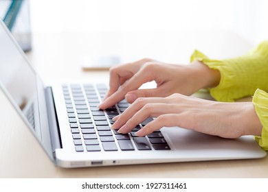 Closeup of hand young asian businesswoman working on laptop computer on desk at home office, freelance looking and typing on notebook on table, woman studying online, business and education concept.