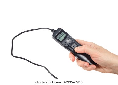 Closeup of handheld camera timer remote with lcd display and buttons, used for time lapse or long exposure, suitable for e-commerce, product guides or photo gear advertisement