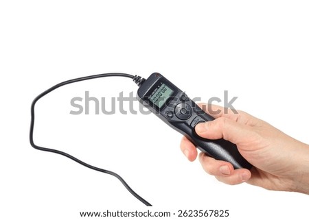 Closeup of handheld camera timer remote with lcd display and buttons, used for time lapse or long exposure, suitable for e-commerce, product guides or photo gear advertisement